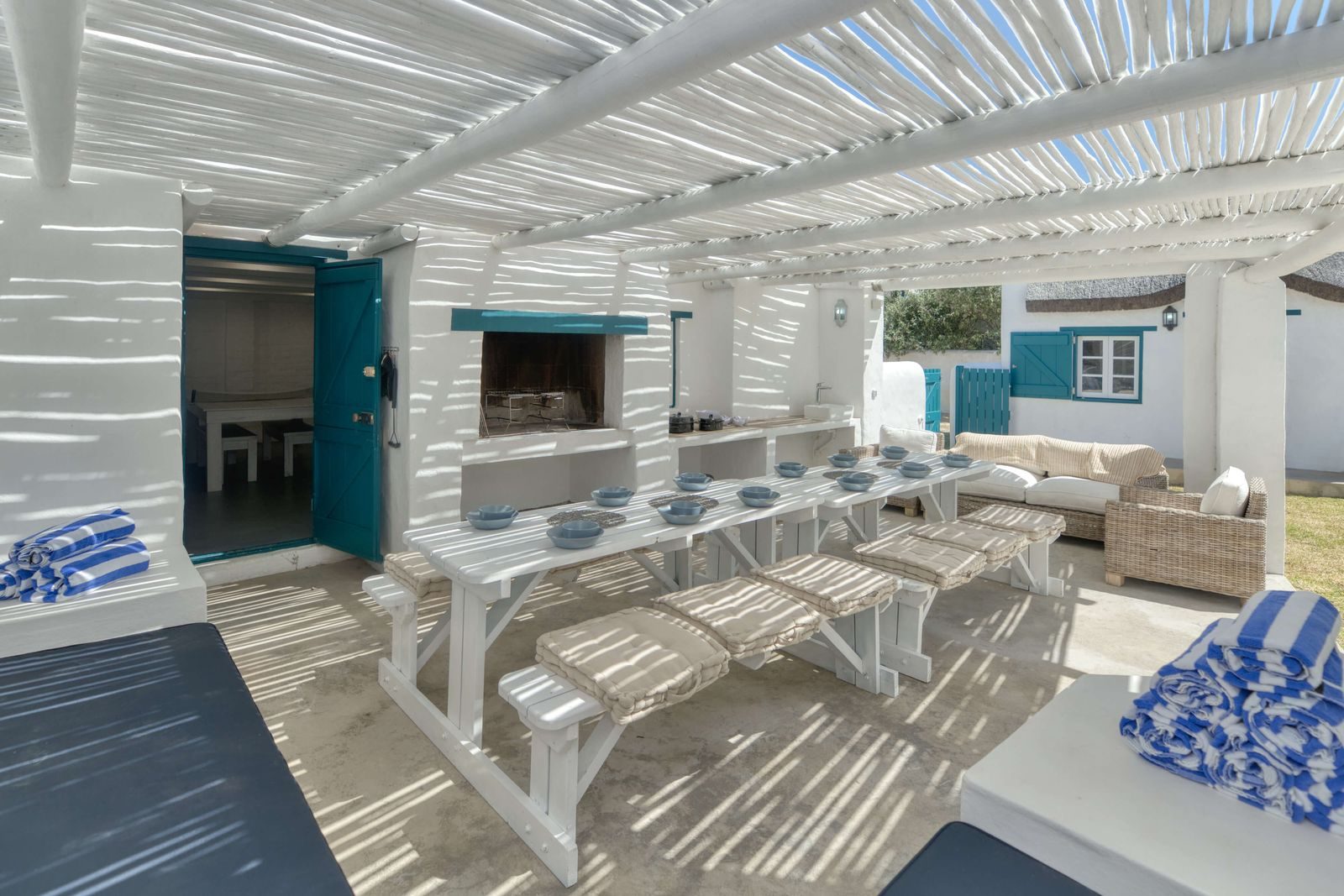 The pergola braai at Cape Creek Retreat, its long table and benches laid for a team